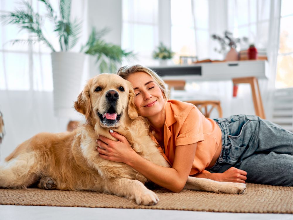 a person laying on the floor with their dog